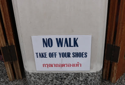 Removal of Shoed sing inside the Wat Pho Bangkok Thailand.