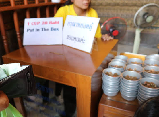 Cup of coins at Reclining Buddha Thailand.